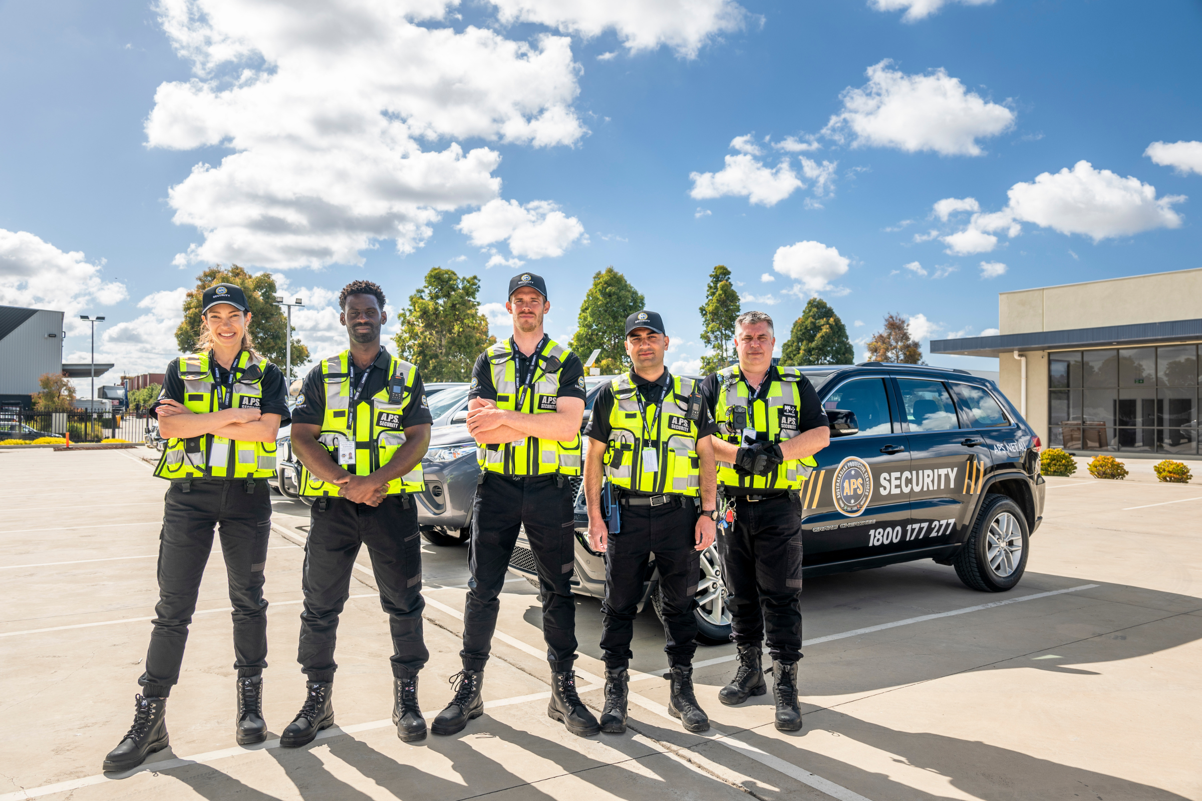 APS Security Guards standing by patrol vehicles
